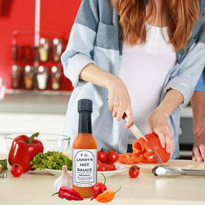 F.U Larry's Hot Sauce Bottle on Kitchen Counter While Person Cooking Recipe